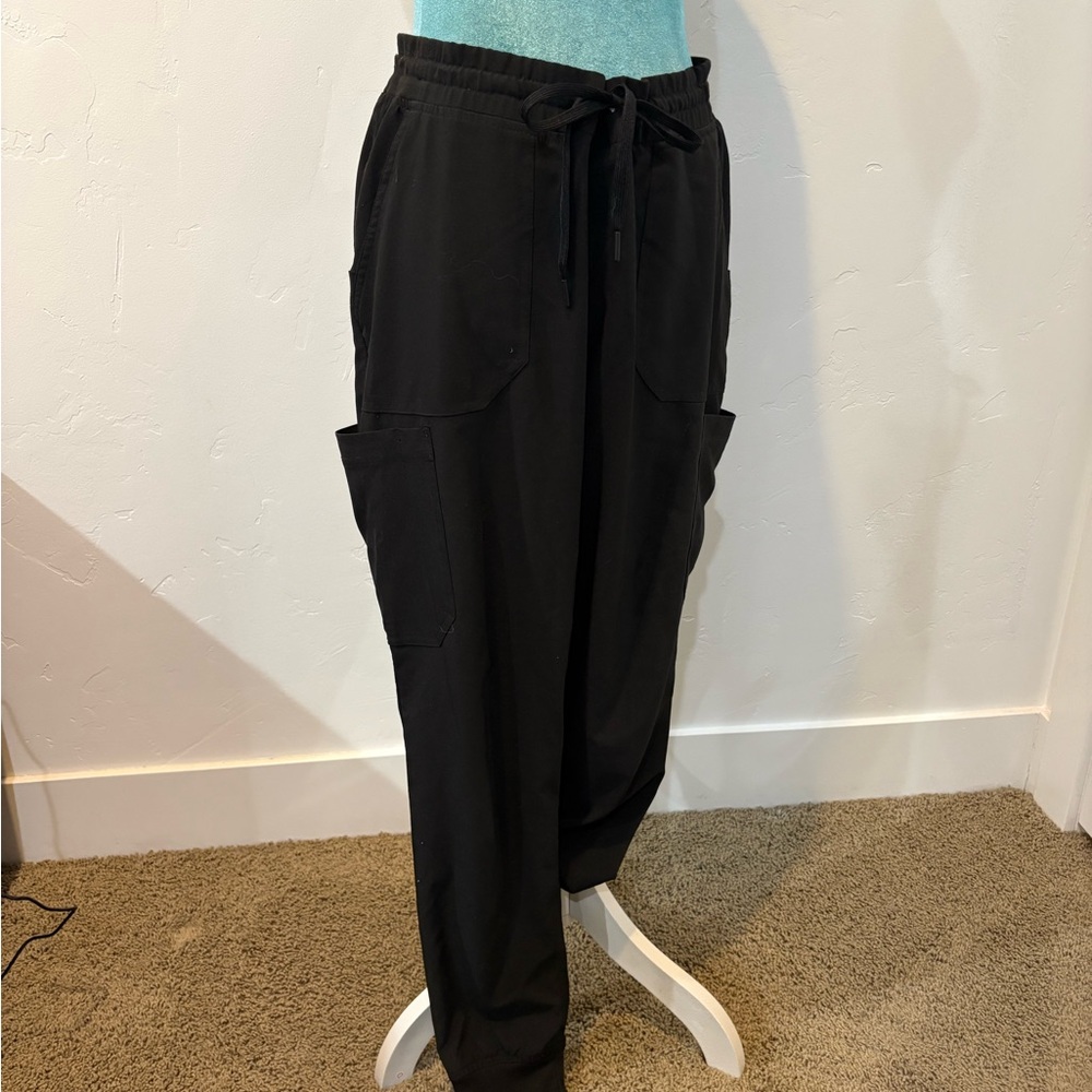Black Carhartt cargo jogger style scrub bottoms.